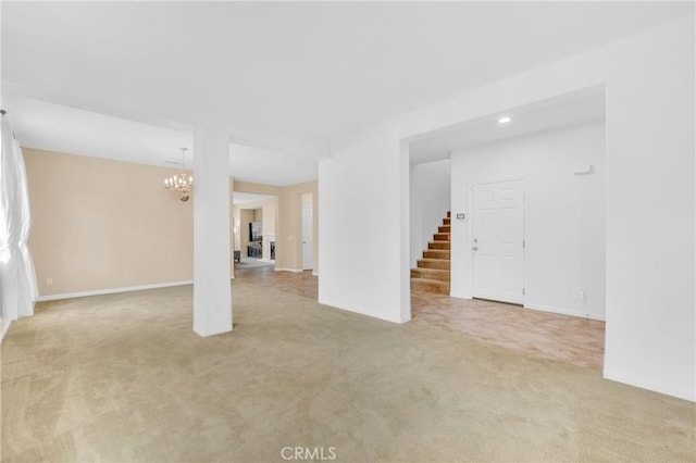 10850 Cameron Ct, Corona, CA 92883 - unfurnished living room with light carpet, a chandelier, and stairway