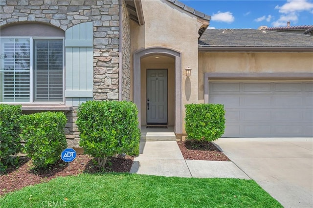10850 Cameron Ct, Corona, CA 92883 - doorway to property featuring driveway, an attached garage, stucco siding, and stone siding