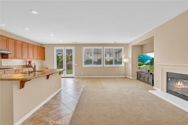 10850 Cameron Ct, Corona, CA 92883 - kitchen featuring plenty of natural light, light tile patterned floors, a kitchen breakfast bar, stainless steel gas cooktop, and recessed lighting