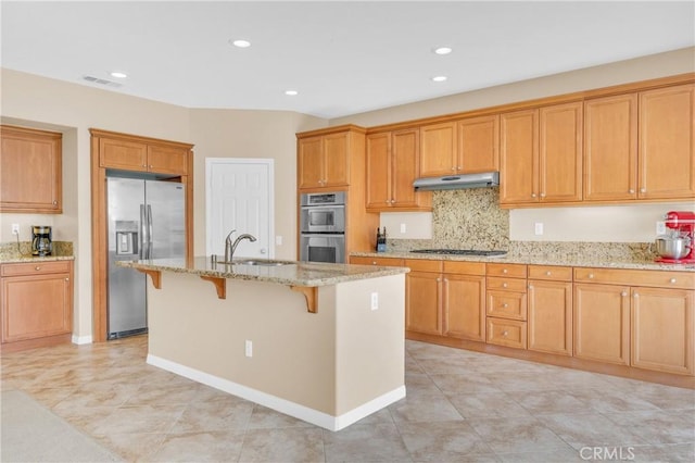 10850 Cameron Ct, Corona, CA 92883 - kitchen featuring stainless steel appliances, under cabinet range hood, a kitchen bar, light stone countertops, and recessed lighting
