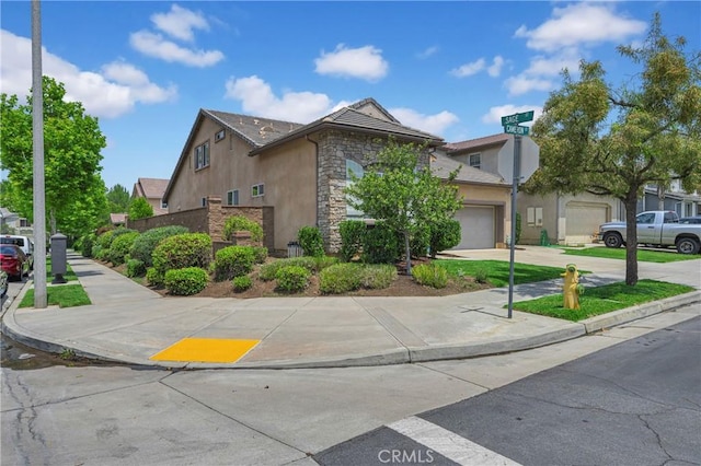 10850 Cameron Ct, Corona, CA 92883 - view of front facade featuring stucco siding, stone siding, driveway, and an attached garage