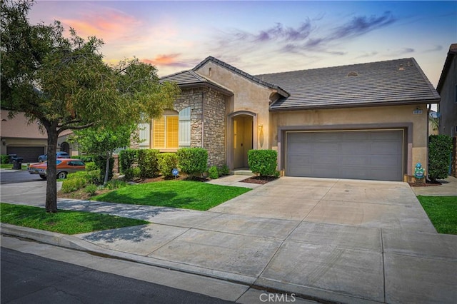 10850 Cameron Ct, Corona, CA 92883 - view of front facade featuring stone siding, concrete driveway, an attached garage, stucco siding, and a tiled roof