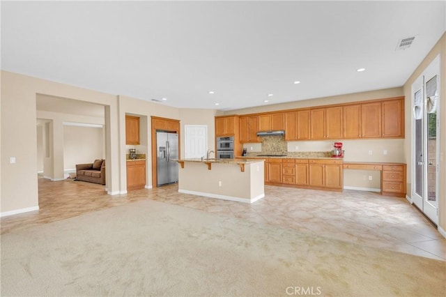 10850 Cameron Ct, Corona, CA 92883 - kitchen with stainless steel appliances, a kitchen bar, light colored carpet, open floor plan, and recessed lighting