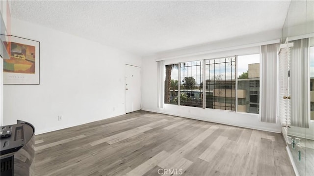 4431 Don Ricardo Dr Unit 20, Los Angeles, CA 90008 - unfurnished room featuring a textured ceiling and wood finished floors