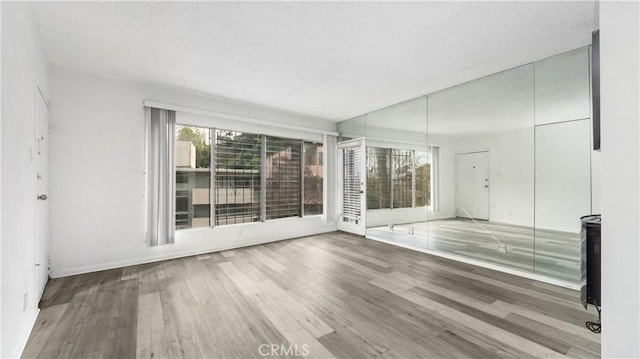 4431 Don Ricardo Dr Unit 20, Los Angeles, CA 90008 - spare room featuring wood finished floors and a textured ceiling