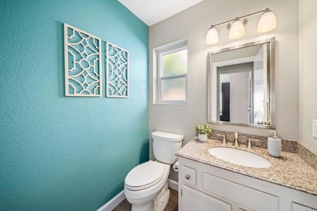 4507 Carnaby Ct, Carlsbad, CA 92010 - half bathroom with vanity, a textured wall, and wood finished floors