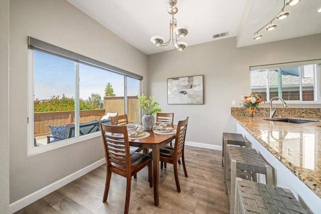 4507 Carnaby Ct, Carlsbad, CA 92010 - dining space with wood finished floors and a chandelier