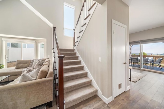 4507 Carnaby Ct, Carlsbad, CA 92010 - staircase featuring wood finished floors and a towering ceiling