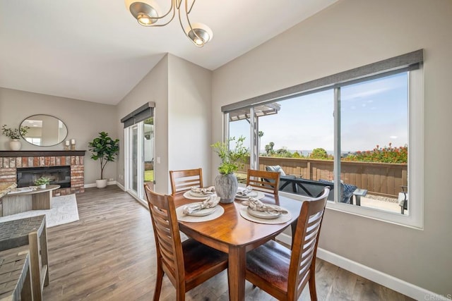 4507 Carnaby Ct, Carlsbad, CA 92010 - dining space featuring wood finished floors, a fireplace, and a chandelier