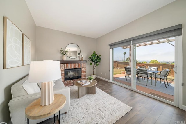 4507 Carnaby Ct, Carlsbad, CA 92010 - living area featuring wood finished floors and a brick fireplace