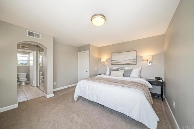4507 Carnaby Ct, Carlsbad, CA 92010 - carpeted bedroom with arched walkways and ensuite bathroom