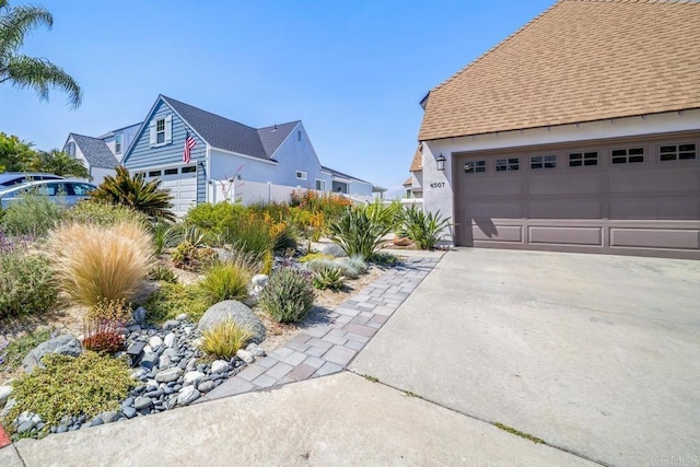 4507 Carnaby Ct, Carlsbad, CA 92010 - view of property exterior featuring a garage, roof with shingles, and stucco siding