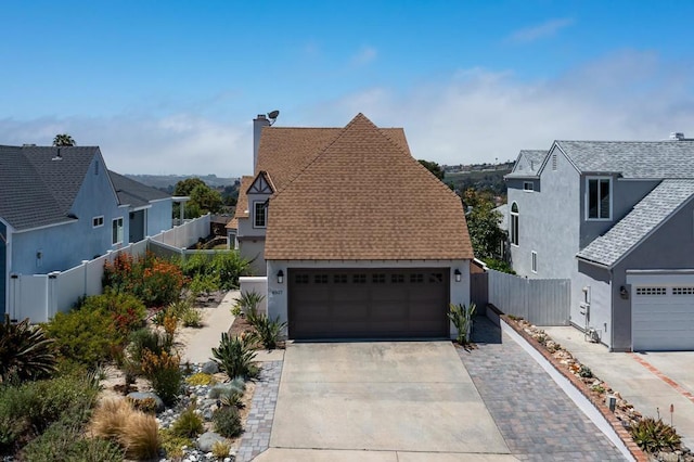 4507 Carnaby Ct, Carlsbad, CA 92010 - view of front of house with stucco siding, a garage, a shingled roof, and a chimney