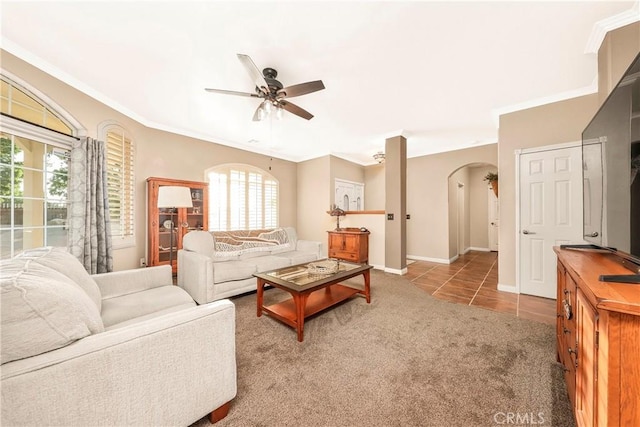 33430 133rd St E, Pearblossom, CA 93553 - tiled living area featuring ceiling fan, arched walkways, crown molding, and carpet floors