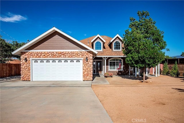 33430 133rd St E, Pearblossom, CA 93553 - view of front of property featuring driveway, stone siding, and an attached garage