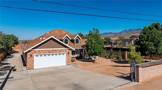 33430 133rd St E, Pearblossom, CA 93553 - view of front of house with stone siding, concrete driveway, a mountain view, and a garage