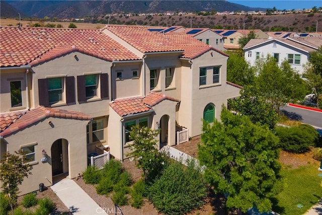 4271 Horvath St Unit 103, Corona, CA 92883 - mediterranean / spanish house featuring a tile roof, stucco siding, a mountain view, and a residential view