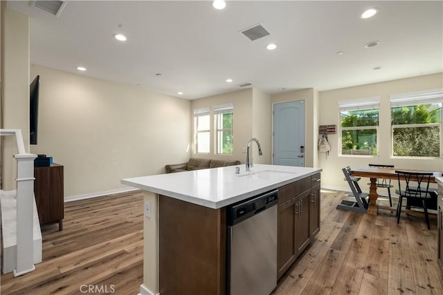4271 Horvath St Unit 103, Corona, CA 92883 - kitchen with dishwasher, wood finished floors, light countertops, an island with sink, and recessed lighting