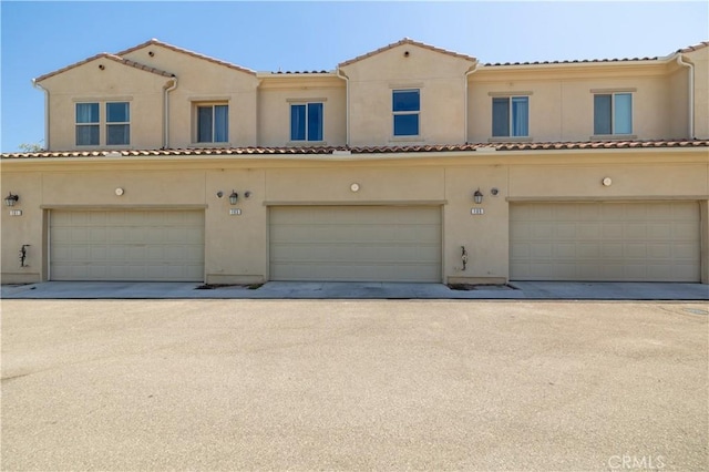 4271 Horvath St Unit 103, Corona, CA 92883 - view of front of house with a garage and stucco siding