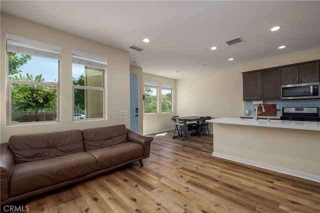 4271 Horvath St Unit 103, Corona, CA 92883 - living room with light wood-type flooring and recessed lighting
