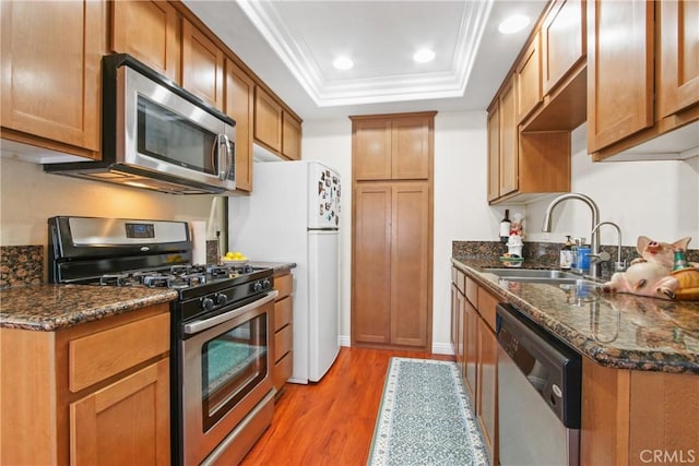 1469 Forest Glen Dr Unit 193, Hacienda Heights, CA 91745 - kitchen with appliances with stainless steel finishes, light wood finished floors, a raised ceiling, crown molding, and brown cabinetry