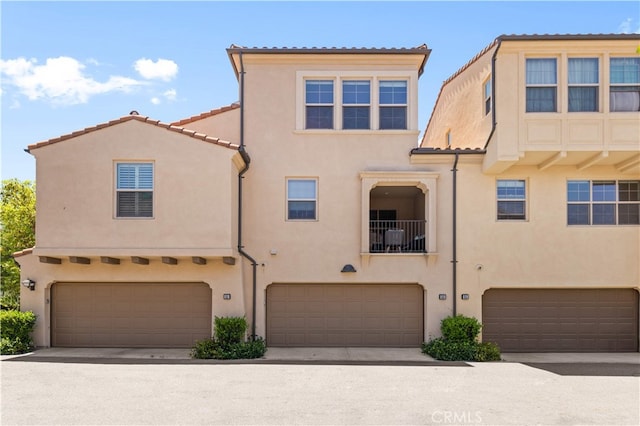 53 Bay Laurel, Irvine, CA 92620 - view of front of home featuring an attached garage, stucco siding, and a tile roof