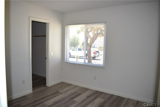 13548 Mount Ranier Way, Hesperia, CA 92345 - unfurnished bedroom with wood finished floors, a closet, and a walk in closet