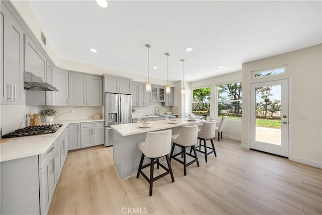 2943 Westbourne Pl, Rowland Heights, CA 91748 - kitchen with stainless steel appliances, gray cabinetry, under cabinet range hood, recessed lighting, and a kitchen breakfast bar