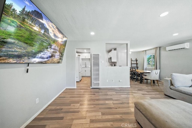 149 S Mistletoe Ave, San Jacinto, CA 92583 - living room with a wall unit AC, light wood finished floors, recessed lighting, and a heating unit