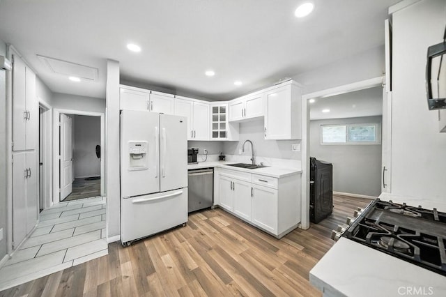 149 S Mistletoe Ave, San Jacinto, CA 92583 - kitchen featuring white fridge with ice dispenser, stainless steel dishwasher, light wood-style floors, light countertops, and recessed lighting