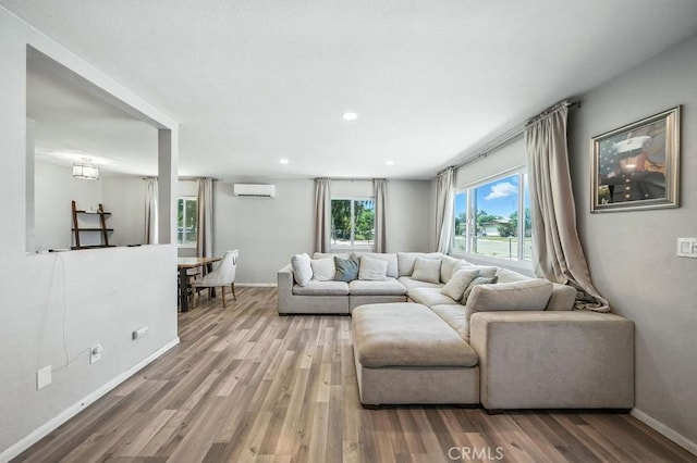 149 S Mistletoe Ave, San Jacinto, CA 92583 - living room with a wall unit AC, wood finished floors, and recessed lighting