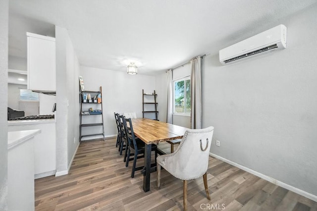 149 S Mistletoe Ave, San Jacinto, CA 92583 - dining room featuring a wall unit AC and wood finished floors