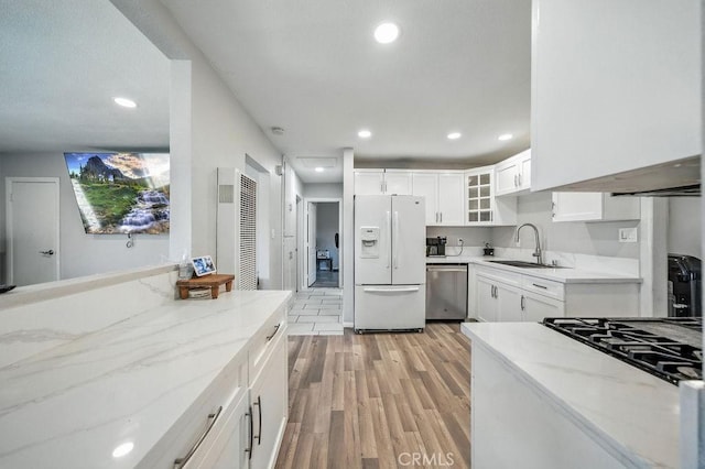 149 S Mistletoe Ave, San Jacinto, CA 92583 - kitchen featuring white fridge with ice dispenser, dishwasher, a heating unit, light stone counters, and light wood-style floors
