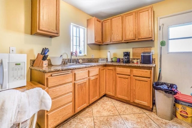 9130 Hargill, Bellflower, CA 90706 - kitchen with white microwave, plenty of natural light, and light tile patterned floors