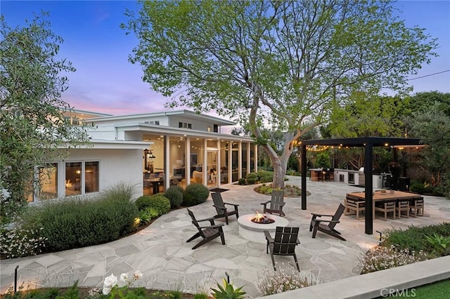 2301 Santiago Dr, Newport Beach, CA 92660 - patio terrace at dusk featuring an outdoor fire pit, a patio area, and a sunroom