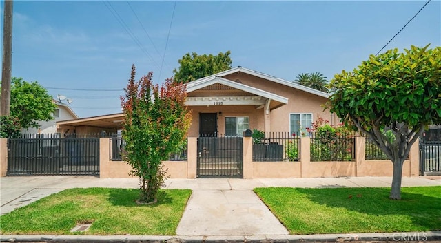 1613 W 56th St, Los Angeles, CA 90062 - bungalow-style home featuring a fenced front yard, stucco siding, and a gate
