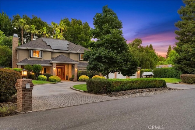 3130 Shady Grove Ct, Chico, CA 95973 - view of front of property featuring decorative driveway, a chimney, and roof mounted solar panels