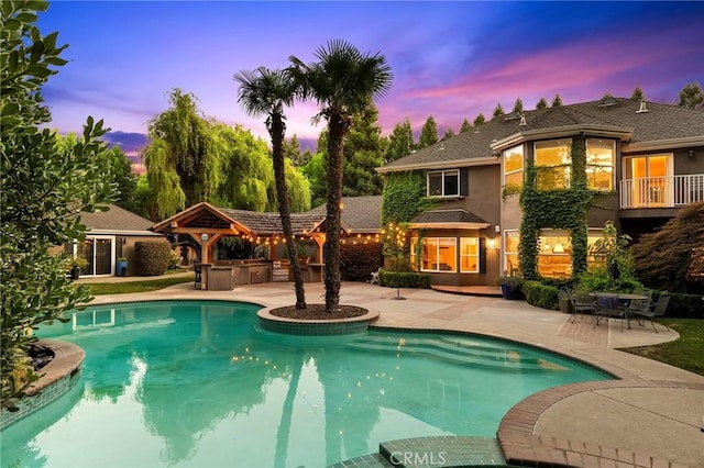 3130 Shady Grove Ct, Chico, CA 95973 - pool at dusk with an outdoor pool, a patio, and an outdoor kitchen