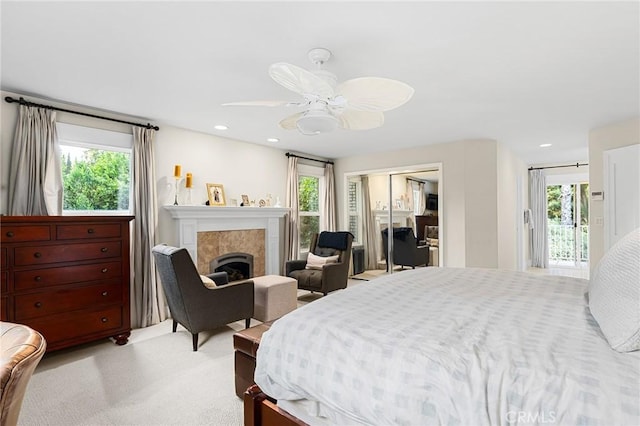 3130 Shady Grove Ct, Chico, CA 95973 - bedroom featuring light colored carpet, a closet, a tile fireplace, access to exterior, and ceiling fan