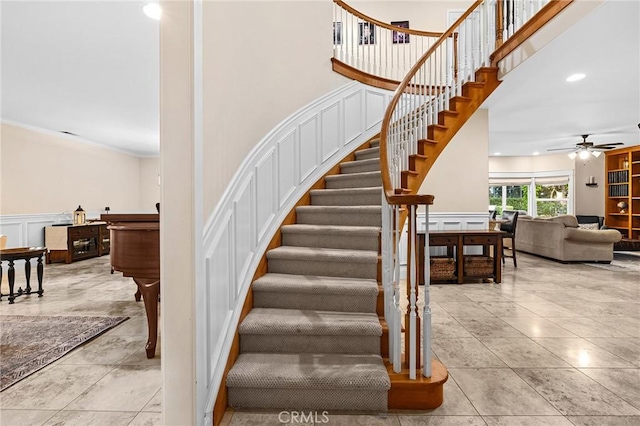 3130 Shady Grove Ct, Chico, CA 95973 - stairs featuring a decorative wall, a ceiling fan, ornamental molding, a wainscoted wall, and tile patterned floors
