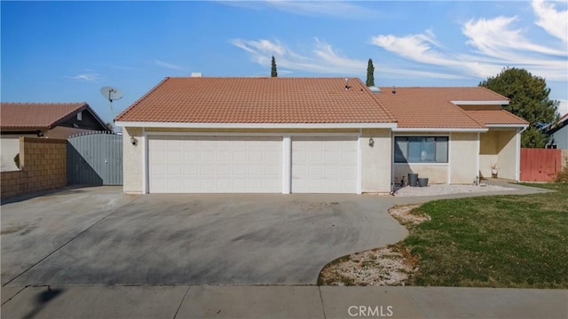 6231 Almond Valley Way, Quartz Hill, CA 93536 - view of front facade featuring concrete driveway, a tile roof, an attached garage, and stucco siding