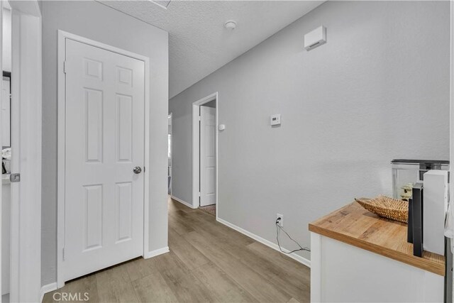 6231 Almond Valley Way, Quartz Hill, CA 93536 - hallway featuring wood finished floors and a textured ceiling