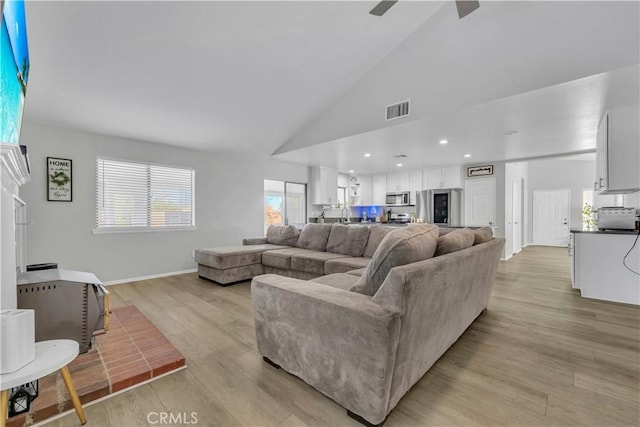 6231 Almond Valley Way, Quartz Hill, CA 93536 - living area with light wood finished floors, high vaulted ceiling, and a ceiling fan