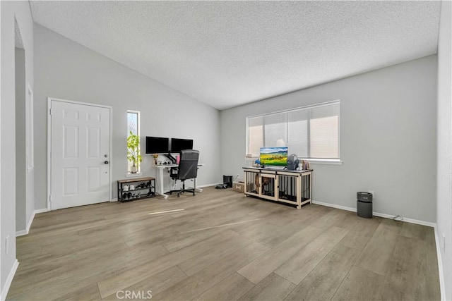 6231 Almond Valley Way, Quartz Hill, CA 93536 - office area with wood finished floors, vaulted ceiling, and a textured ceiling