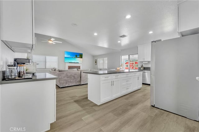 6231 Almond Valley Way, Quartz Hill, CA 93536 - kitchen with freestanding refrigerator, stainless steel dishwasher, white cabinetry, ceiling fan, and light wood-type flooring