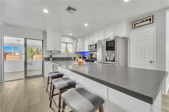 6231 Almond Valley Way, Quartz Hill, CA 93536 - kitchen featuring stainless steel appliances, dark countertops, white cabinets, open shelves, and recessed lighting