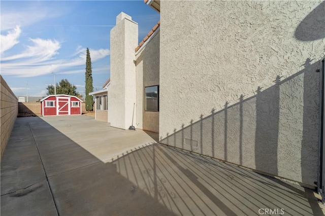 6231 Almond Valley Way, Quartz Hill, CA 93536 - view of side of property featuring stucco siding, a storage unit, and a patio area