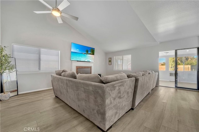 6231 Almond Valley Way, Quartz Hill, CA 93536 - living area with a brick fireplace, light wood finished floors, ceiling fan, and high vaulted ceiling