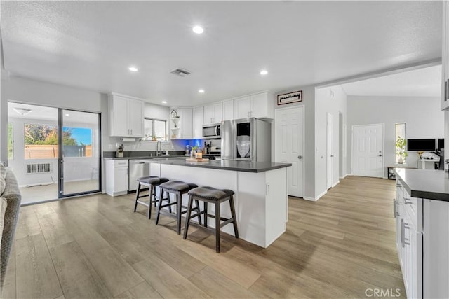 6231 Almond Valley Way, Quartz Hill, CA 93536 - kitchen with stainless steel appliances, dark countertops, white cabinetry, light wood finished floors, and recessed lighting