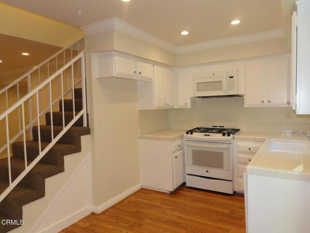 808 Magnolia Ave Unit 3, Pasadena, CA 91106 - kitchen featuring white appliances, tile countertops, light wood-type flooring, white cabinets, and crown molding